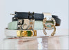Stacked vintage designer belts with statement buckles and jeweled details