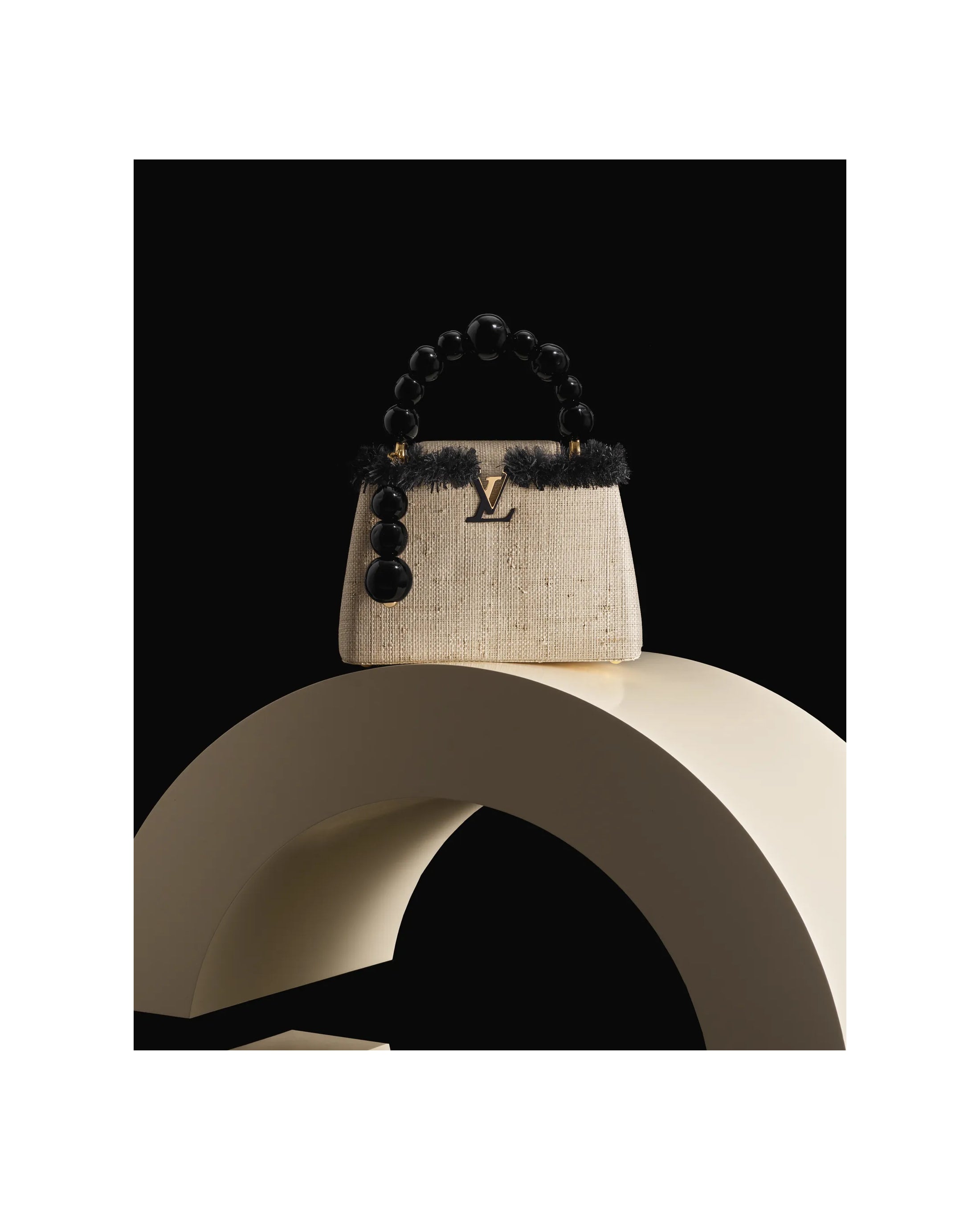 Elegant handbag with black beaded handle, displayed on a sculptural pedestal - HerAge